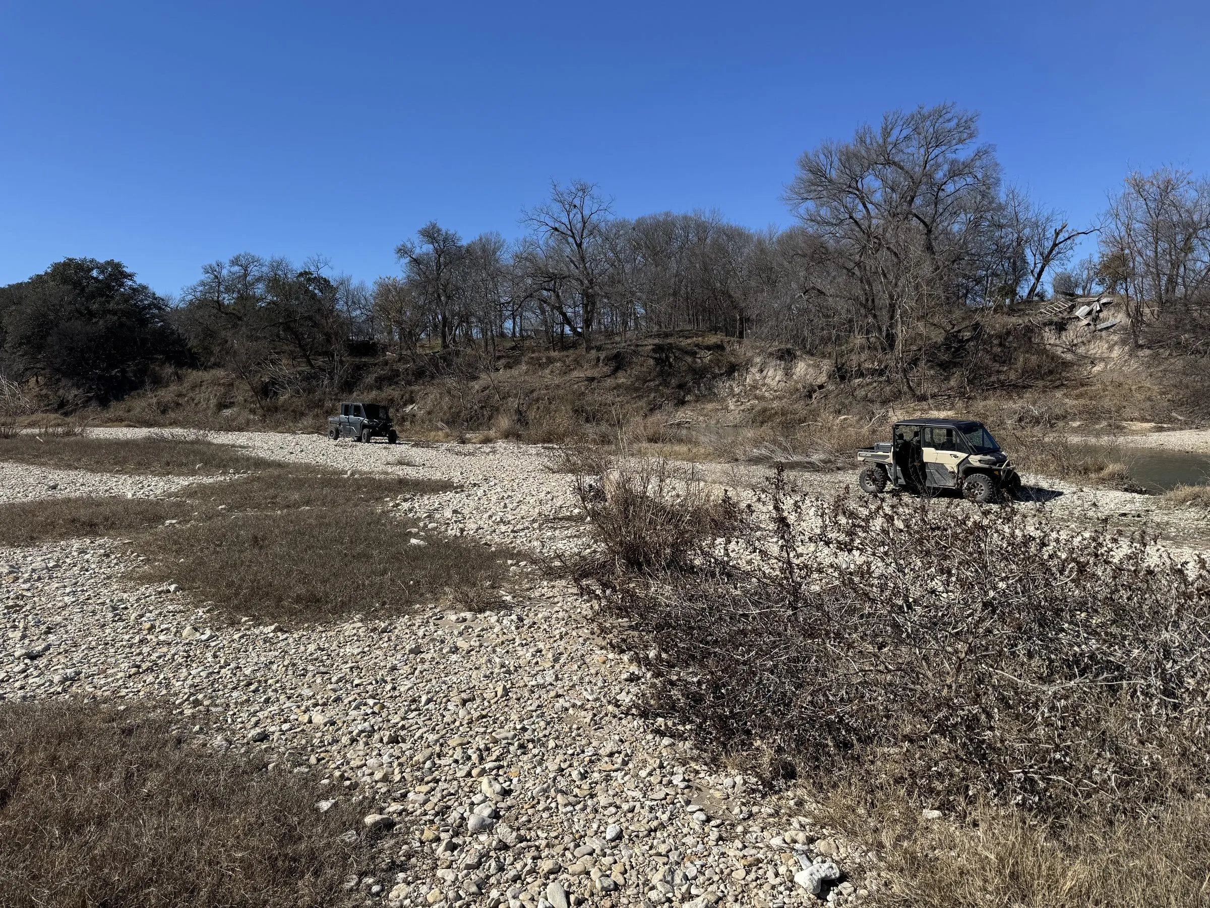 Dry creek bed across exposed Texas land. A quiet visual of where water used to run.